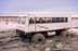 Tundra buggy travelling through pond